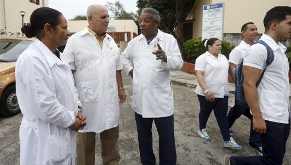 Doctors chat at the entrance of a hospital in Havana.