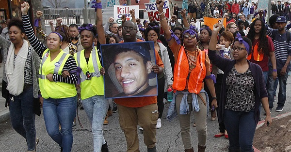 People protest the fatal police shooting of unarmed Black man Anthony Hill in Decatur, Georgia March 11, 2015.