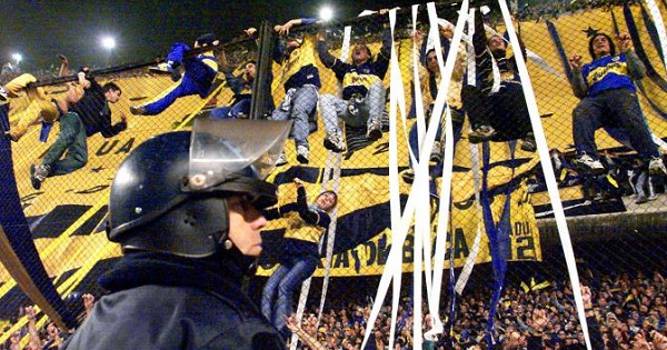 Boca Juniors fans are seen cheering for their team during a match.