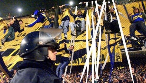 Boca Juniors fans are seen cheering for their team during a match.