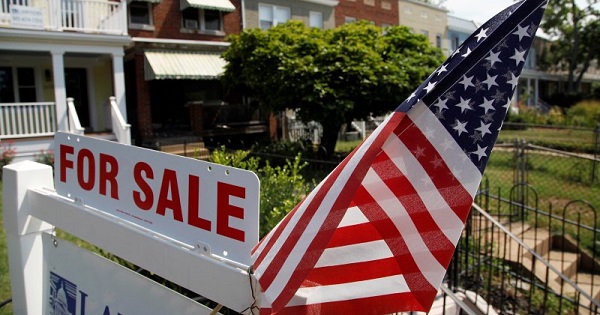 A U.S. flag decorates a for-sale sign at a home in the Capitol Hill neighborhood of Washington, August 21, 2012.