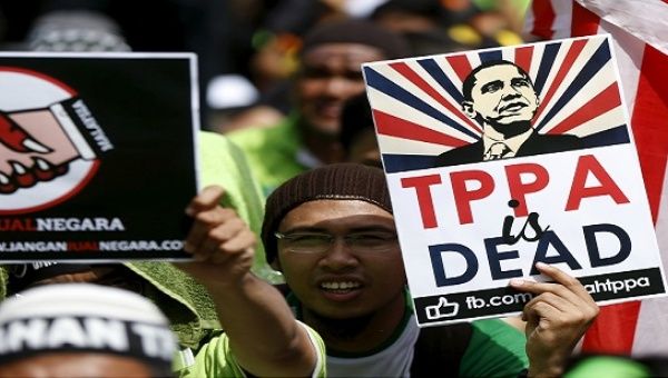 Protesters wave placards at a rally against the Trans-Pacific Partnership (TPP) in Kuala Lumpur, Malaysia, Jan. 23, 2016. 