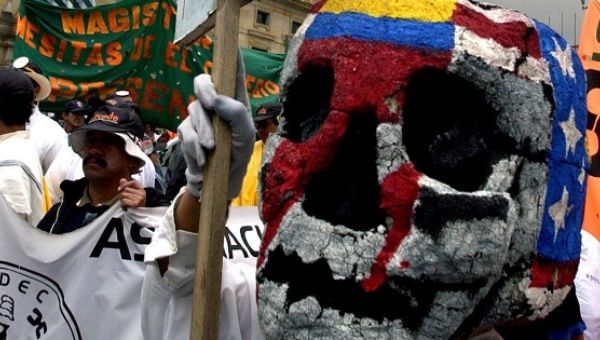 A worker with a mask with the U.S. and Colombian flags painted on it protests in the Plaza Bolivar in Bogota, Colombia.