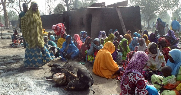 Women sit beside the burnt carcass of a cow after Boko Haram attacks at Dalori village on the outskirts of Maiduguri in northeastern Nigeria Jan. 31, 2016