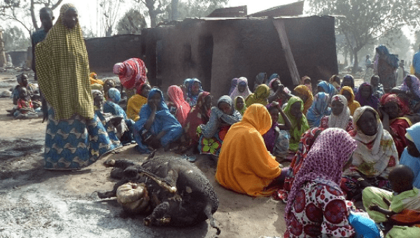 Women sit beside the burnt carcass of a cow after Boko Haram attacks at Dalori village on the outskirts of Maiduguri in northeastern Nigeria Jan. 31, 2016