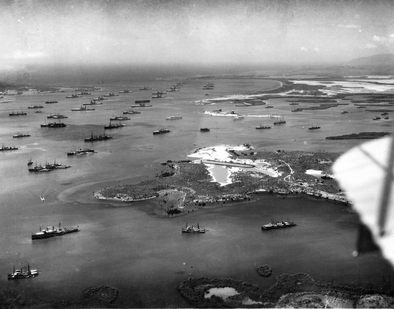 Ships of the U.S. Fleet pictured at anchor at Guantanamo Bay, Cuba, during winter exercises in 1927. Visible amidst about 15 battleships at the top of the photograph is the aircraft carrier USS Langley (CV-1). Also visible are two Omaha-class cruisers, at least 17 destroyers, and two submarine tenders in the foreground with about 10 smaller and two large submarines. The peninsula in the right foreground is South Toro Cay, where the drydock is still visible that was begun in 1904, but cancelled two years later.