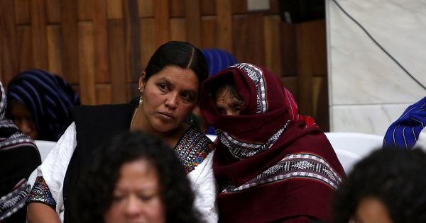 A witness in the Sepur Zarco trial hides her face with a headscarf.