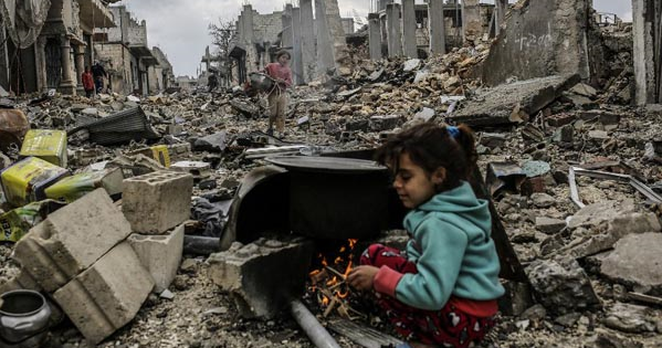 Kurdish Syrian girls are pictured among destroyed buildings in the Syrian Kurdish town of Kobane.