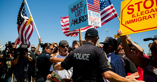 Demonstrators picketing against the arrival of undocumented migrants who were scheduled to be processed at the Murrieta Border Patrol Station block the buses carrying the migrants in Murrieta, California July 1, 2014.