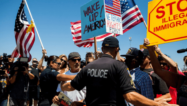 Demonstrators picketing against the arrival of undocumented migrants who were scheduled to be processed at the Murrieta Border Patrol Station block the buses carrying the migrants in Murrieta, California July 1, 2014.