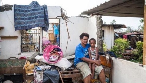 Fijian woman holds her son in the remnants of her home damaged by Cyclone Winston in the Rakiraki District of Fiji's Ra province, Feb. 24, 2016.