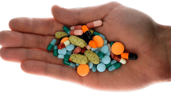 Hand with an assortment of pills.