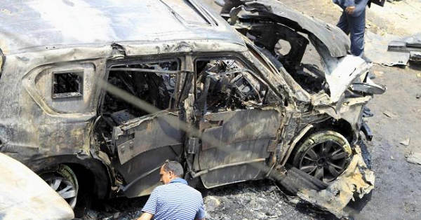 A crime scene investigator investigates the site of a car bomb attack on the convoy of Egyptian public prosecutor Hisham Barakat near his house at Heliopolis district in Cairo, June 29, 2015.