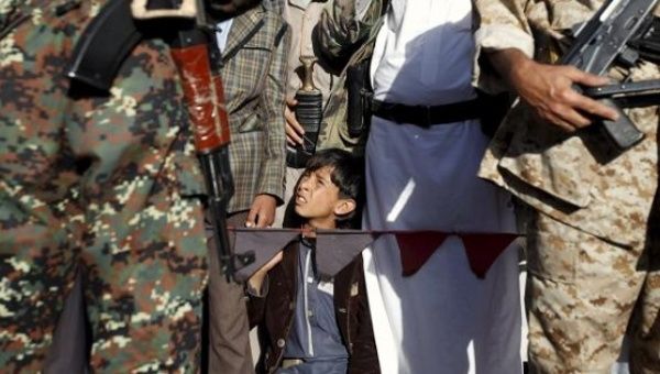 A young child looks on as he takes part in a demonstration against Saudi-led strikes in Yemen's capital Sanaa on Nov. 20, 2015.