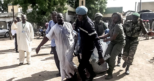 Security forces transport with a blanket the remains of some of the eleven victims of a double blast in the northern Cameroonian city of Maroua on July 22, 2015, after two girls blew themselves up in twin attacks.