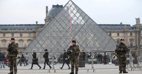 French soldiers patrol in front of the Louvre Museum Pyramid's main entrance in Paris, France, as part of France's national security alert system ''Sentinelle'' after Paris deadly attacks Nov. 27, 2015.