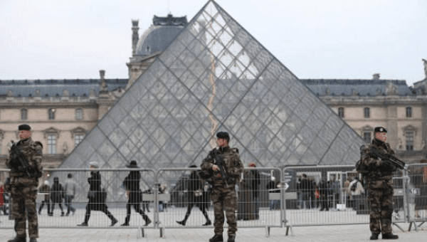 French soldiers patrol in front of the Louvre Museum Pyramid's main entrance in Paris, France, as part of France's national security alert system ''Sentinelle'' after Paris deadly attacks Nov. 27, 2015.