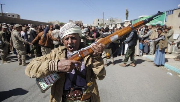 A Houthi militant carries his weapon during a funeral, Sanaa, Feb. 18, 2016.