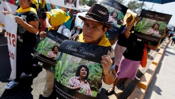 An Indigenous woman holds a poster with a photograph of Berta Caceres during a march to demand justice in Tegucigalpa, Honduras, March 16, 2016. 