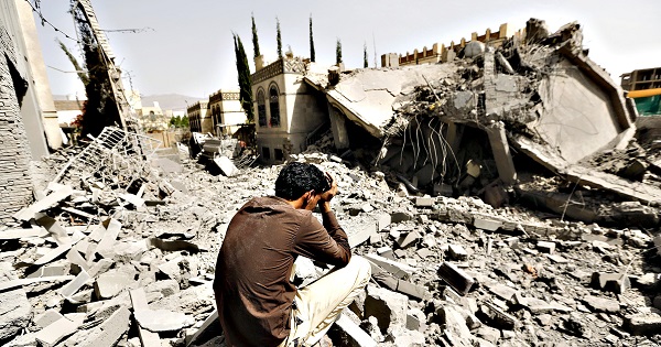 A Yesits on the rubble of a house after air strikes destroyed it in Sanaa, Yemen, on Monday