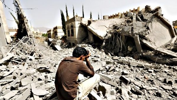 A Yesits on the rubble of a house after air strikes destroyed it in Sanaa, Yemen, on Monday