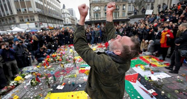 A man reacts at a street memorial following Tuesday's bomb attacks in Brussels, Belgium, March 23, 2016.