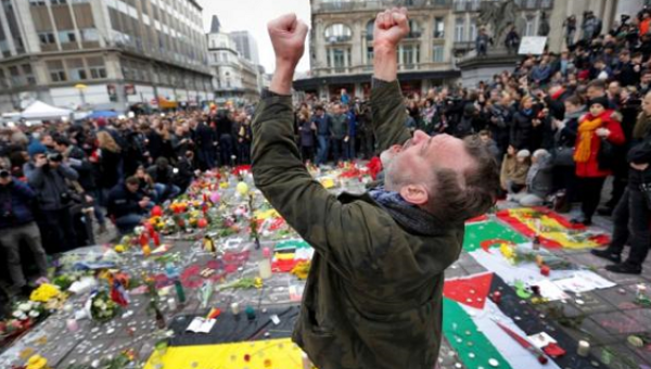 A man reacts at a street memorial following Tuesday's bomb attacks in Brussels, Belgium, March 23, 2016.