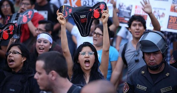 A demonstrator holds up a uterus protest sign representing victims of forced sterilization under Alberto Fujimori during a protest against Keiko Fujimori in Lima, Peru, March 11, 2016.