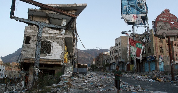 Man walks past a building destroyed during recent fighting in Yemen's southwestern city of Taiz.