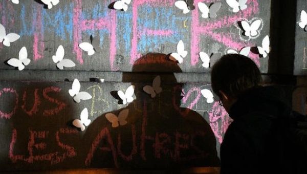 A man lights a candle as he attends a gathering to pay tribute to the victims of the Brussels attacks on the Place de la Bourse (Beursplein) in central Brussels, on March 25, 2016. 