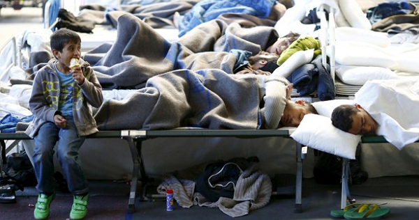 Migrants rest at a temporary shelter in a sports hall in Hanau, Germany.