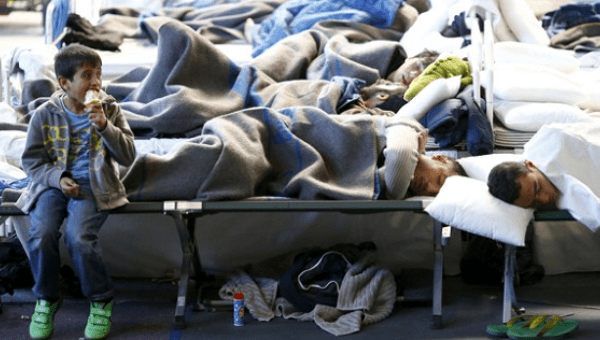 Migrants rest at a temporary shelter in a sports hall in Hanau, Germany.