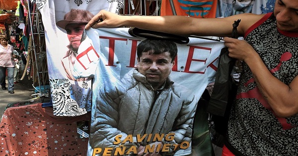 A woman displays a T-shirt with the image of Joaquín 