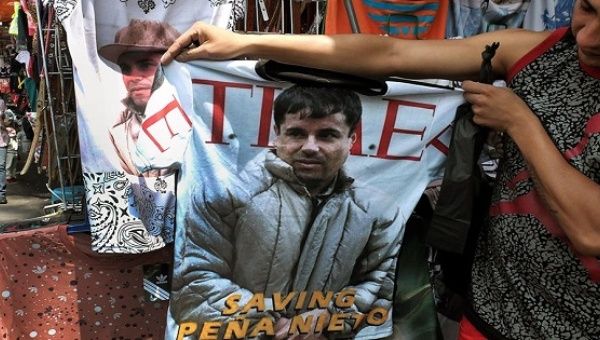 A woman displays a T-shirt with the image of Joaquín 