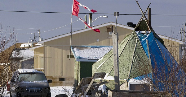 A tattered Canadian flag flies over a teepee in Attawapiskat, Ontario, in this file photo taken December 17, 2011.