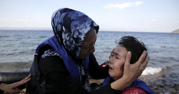 An Afghan mother comforts her crying child moments after a dinghy carrying Afghan migrants arrived on the island of Lesbos, Greece August 23, 2015.