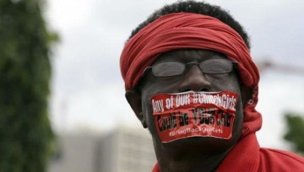 Protester in Nigeria demands the government to stop Boko Haram abductions and rescue the 219 girls still abducted by the extremist group.