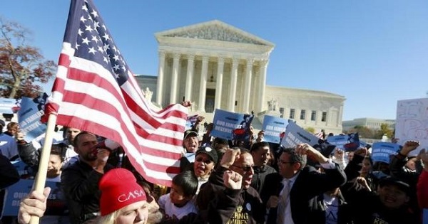 Immigrants and community leaders rally in front of the U.S. Supreme Court to mark the one-year anniversary of Obama's executive orders on immigration in Washington, Nov. 20, 2015