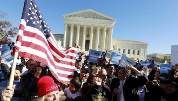 Immigrants and community leaders rally in front of the U.S. Supreme Court to mark the one-year anniversary of Obama's executive orders on immigration in Washington, Nov. 20, 2015