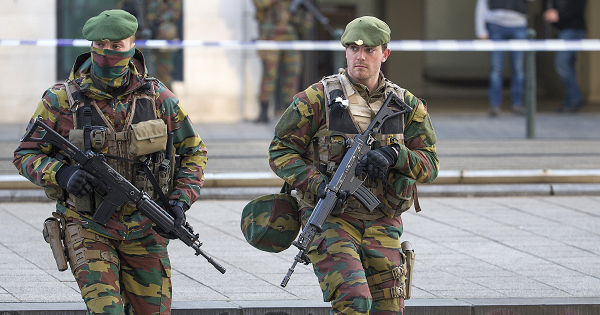 A Belgian special forces police officer and soldiers secure the zone outside a courthouse, while Brussels attacks suspects Mohamed Abrini and Osama Krayem appear before a judge, in Brussels, Belgium, April 14, 2016.