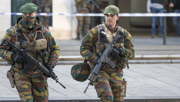 A Belgian special forces police officer and soldiers secure the zone outside a courthouse, while Brussels attacks suspects Mohamed Abrini and Osama Krayem appear before a judge, in Brussels, Belgium, April 14, 2016.