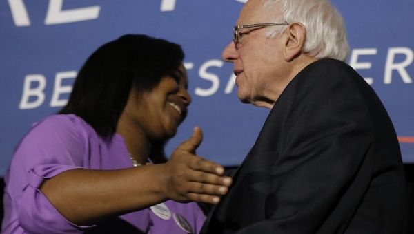 Bernie Sanders is embraced by Erica Garner, daughter of the late Eric Garner, at a town hall in Columbia, South Carolina, on Feb. 16. 