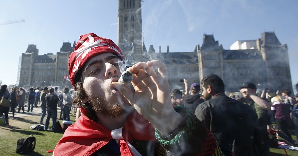 A man smokes marijuana during an annual 4/20 rally on Parliament Hill in Ottawa, Canada, April 20, 2016.