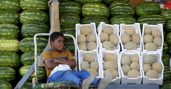 A Saudi boy sells melons and watermelons in Riyadh, Saudi Arabia, April 25, 2016.