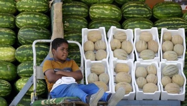 A Saudi boy sells melons and watermelons in Riyadh, Saudi Arabia, April 25, 2016.