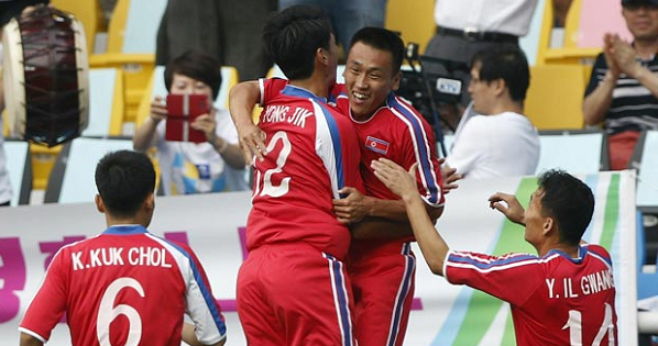 North Korean footballers celebrate.