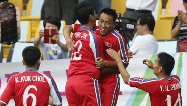 North Korean footballers celebrate.