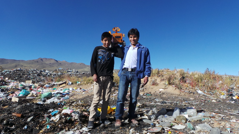 Esteban and his 14-year-old brother Hernan proudly pose with their robot Wall-E.