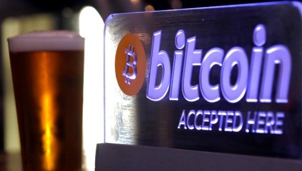 A Bitcoin sign on display at a bar in central Sydney, Australia.