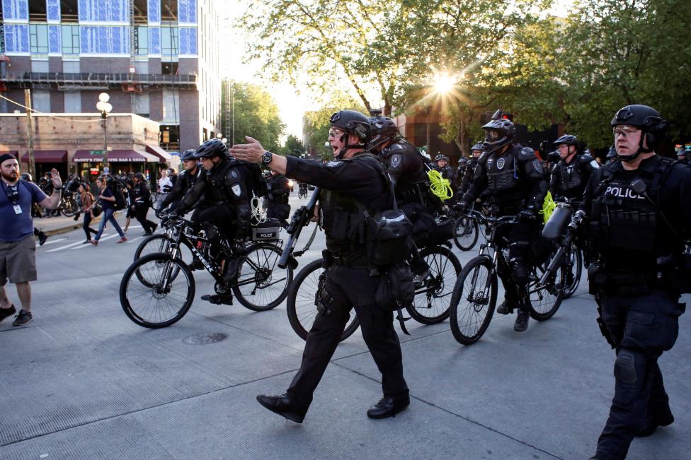 Police disperse protesters.